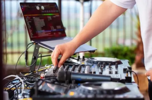 "DJ performing at a private party, representing liability insurance coverage for entertainers and music professionals.
